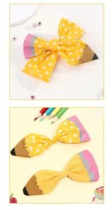 Detail of handmade pencil-themed hair bow with polka dots for school-season hair accessories