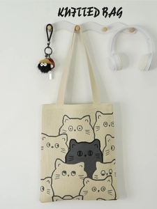 Minimalist beige knitted tote bag featuring stylish black and white cat patterns for women