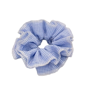 Sweet blue and white gingham fabric scrunchie with detailed stitching on white background