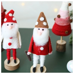 Detail of handmade wool felt Santa gnome with soft plush texture and wooden base