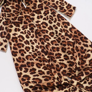 Detailed macro view of leopard print dress fabric texture and professional stitching
