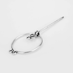 Detailed view of a silver Viking style brooch pin for cloaks and shawls