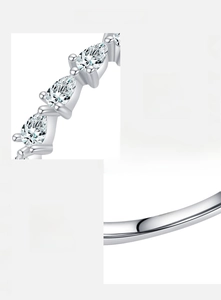 Macro detail of S925 sterling silver ring featuring pear-cut zircon stones and hallmark