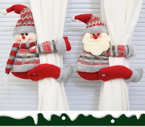 Close-up of Santa and Snowman knitted plush curtain buckles on window blinds