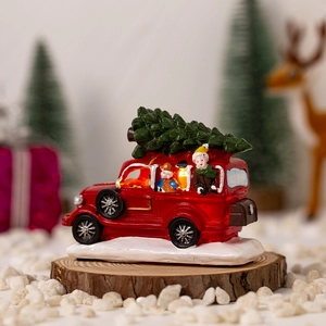 Lighted red vintage truck resin ornament with Christmas tree on a rustic wood base