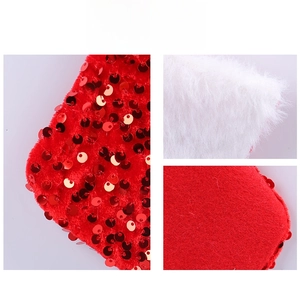 Detailed macro view of sequined velvet and white faux fur texture on a Christmas stocking