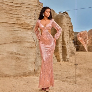 Detail of rose gold sequin evening gown with side cut-outs and V-neckline in outdoor setting