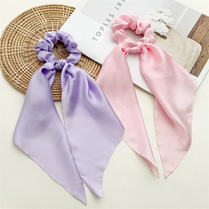Elegant satin hair scrunchies with long ribbons in light purple and soft pink colors
