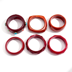 Retro geometric resin bangles in red and orange tones with faceted bohemian designs