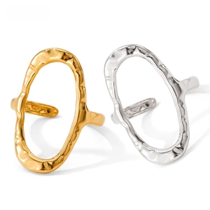 Macro detail of irregular hammered texture on gold and silver stainless steel rings