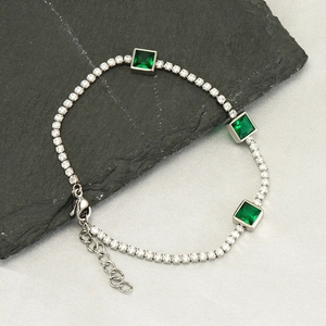 Silver-tone tennis bracelet with green emerald-cut stones and clear cubic zirconia