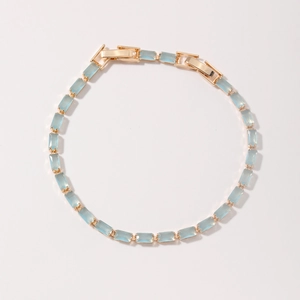Colorful glass bead bracelet with light blue gemstones on golden metal base