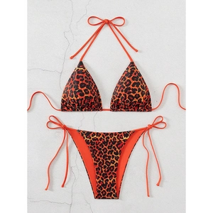 Detailed flat lay of a two-piece bikini set featuring bold leopard print and side ties