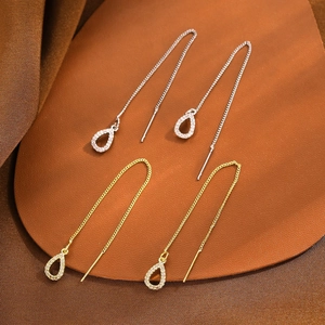 Detailed view of long tassel water-drop earrings in gold and silver finish with zircon