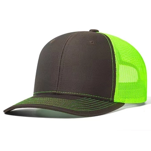 Detail view of brown trucker hat with fluorescent green mesh and multi-row stitching
