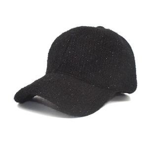 Close-up of black fuzzy baseball cap with silver glitter threads for winter warmth