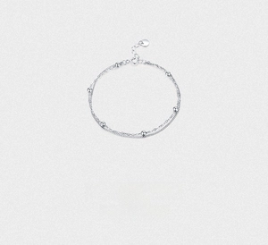 Detail of S925 sterling silver double-layered chain bracelet with polished beads