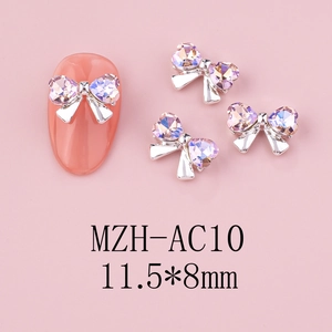 Detailed macro view of 11.5x8mm bow nail art charm with heart-shaped pink rhinestone