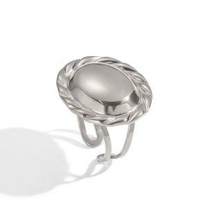 Detailed view of silver oval signet ring with braided edge and adjustable open band