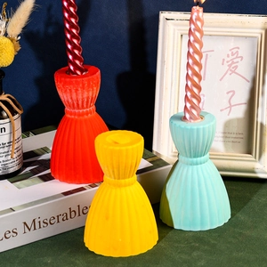 Pleated hourglass candle holder set in red yellow and mint green on vintage books