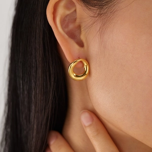 Minimalist irregular streamline golden heart-shaped stainless steel earrings on model