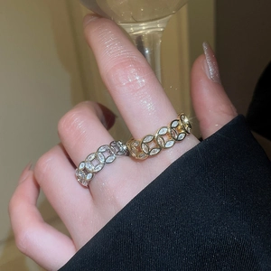 Detailed view of 18k gold and silver plated coin rings with cubic zirconia inlay on a hand