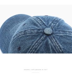 Detailed macro shot of vintage blue denim fabric texture and reinforced baseball cap stitching