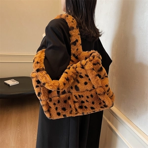 Fashionable brown leopard print plush tote bag shown on model in stylish interior setting