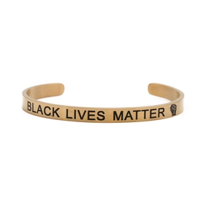 Close-up of golden stainless steel bracelet with Black Lives Matter engraving and icon