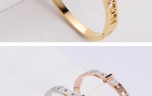 Close-up of polished titanium steel bracelet featuring Roman numerals and pavé cubic zirconia