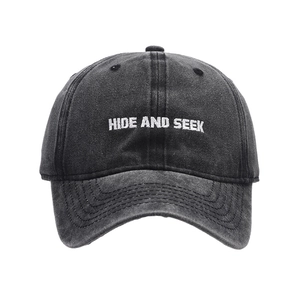 Vintage washed charcoal cotton baseball cap featuring white HIDE AND SEEK embroidery