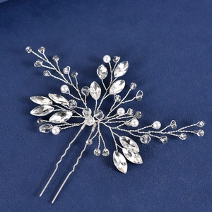 Macro shot of silver bridal hair pin with marquise rhinestones and handmade pearls