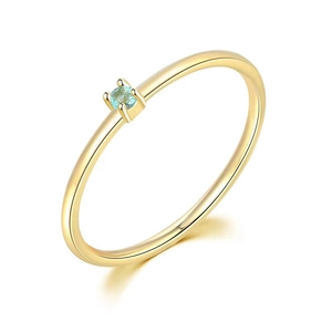 Detailed close-up of a minimalist 18K gold S925 silver ring with light blue gemstone