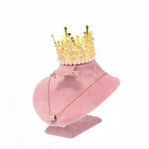 Pink velvet mannequin stand with golden pearl crown and necklace jewelry display