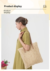 Detail of woven straw tote bag with brown leather shoulder strap on green dress