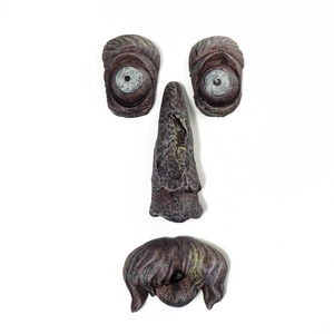 Detailed set of glowing tree face ornaments with textured bark eyes and nose on white