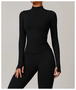 Detail of slim fit yoga jacket with stand-up collar, zipper closure and functional thumbholes