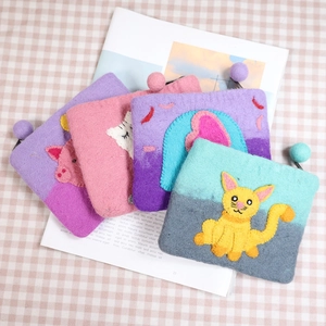 Cute wool felt animal coin purses with handmade embroidery on pink checkered background