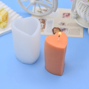 DIY long heart-shaped acrylic candle mold with finished pink heart candle and wick