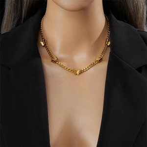 Elegant gold Cuban chain necklace with five butterfly pendants on a black suit model