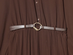 Close-up of pleated brown midi dress featuring a slim belt with a gold ring buckle