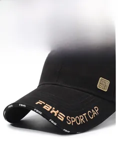 Detailed embroidery of gold letters and metallic label on black cotton baseball cap