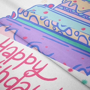 Detail showing soft fabric texture and colorful Happy Birthday cake print on the tapestry
