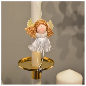 Detailed view of plush angel ornament with brown hair and silver bell on white candle holder