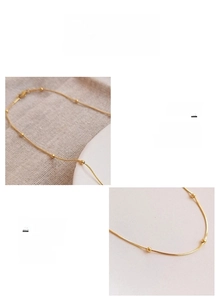 Detailed macro view of an 18K gold plated surgical titanium steel snake bone bead chain