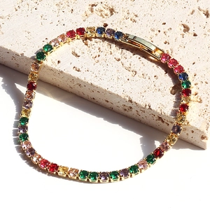 Detailed macro view of gold-plated rainbow tennis bracelet with colorful zircon stones