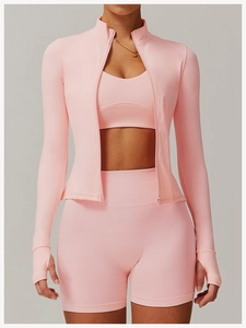 Detailed view of pink zip-up sports jacket with thumbhole sleeves and slim-fit yoga shorts