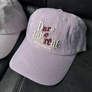 Detail of lavender baseball cap with 3D embroidery on black leather texture