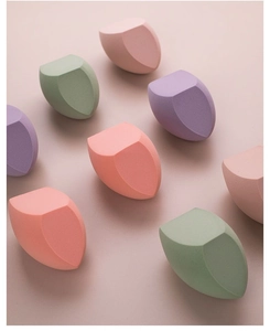 Detailed view of eight large soft makeup sponges in pink, purple and green hues
