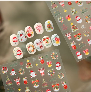 Close-up of 3D embossed Christmas nail stickers with watercolor snowmen and deer